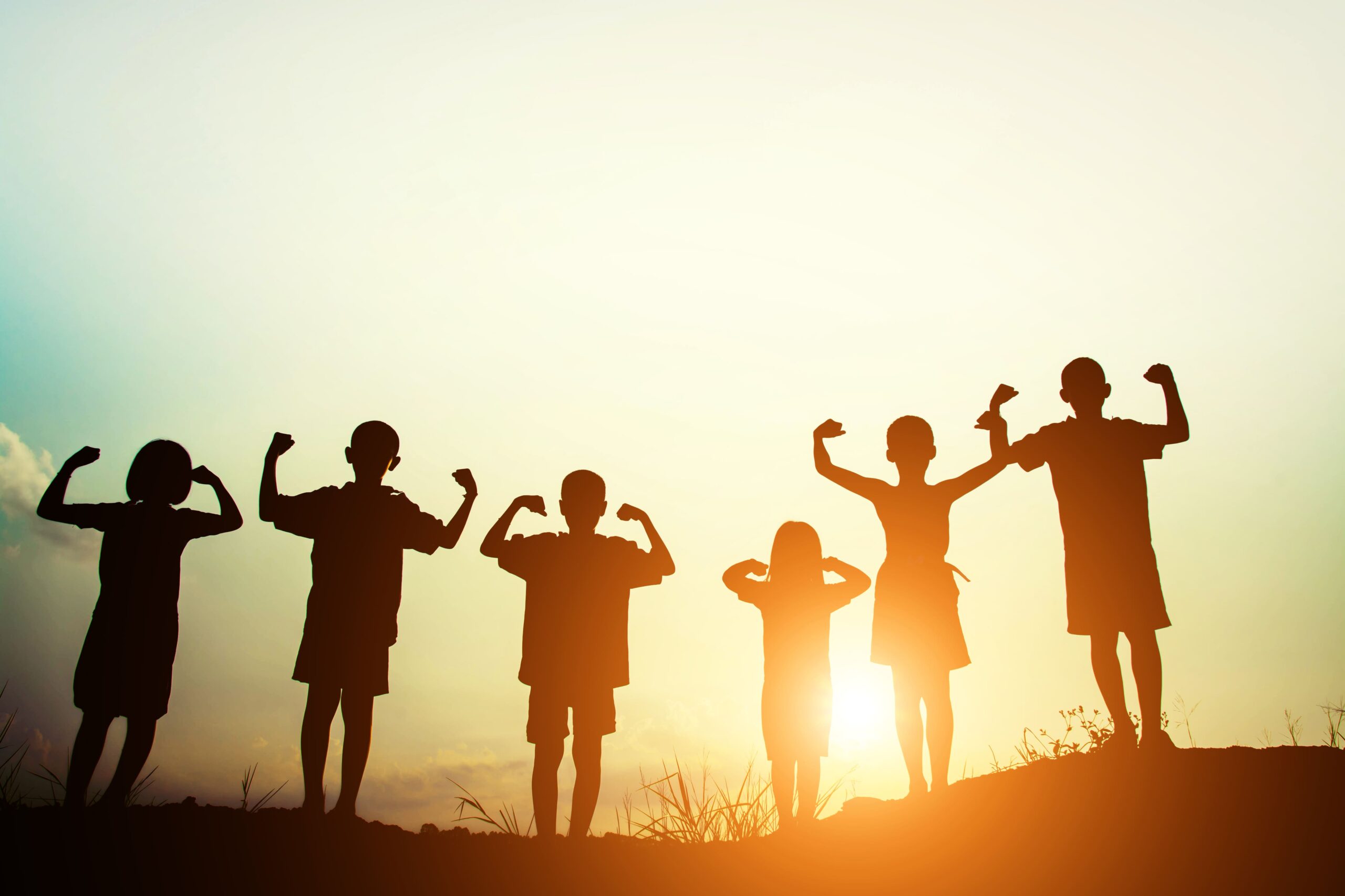 children-s-silhouettes-showing-muscles-sunset (1)